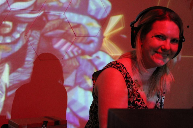 Treetz performing behind the decks under coloured projections