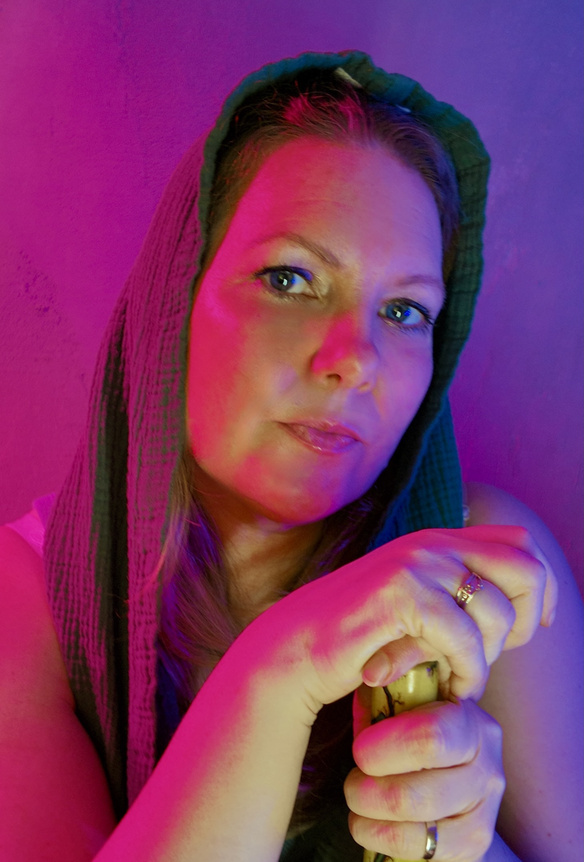 Treetz holding a staff under colourful lighting